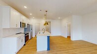 Located at 1748 Marglyn Drive in Matthews, NC, this two-story home offers 3 bedrooms and 4 bathrooms thoughtfully distributed across two levels. The main floor hosts an open-concept living, dining, and kitchen area finished with warm light wood flooring that flows throughout. The kitchen is a standout, featuring crisp white shaker cabinets, stainless steel appliances, a pantry, and a striking center island with a bold navy-blue base, white quartz countertop, and gold pendant lighting overhead — a clear focal point of the home. Recessed lighting brightens the entire main level. A convenient half bath is also located on the main floor, alongside a garage with an automatic opener. Upstairs, the three bedrooms are bright and airy, each benefiting from natural light through sizable windows with blinds and ceiling fans for added comfort. The primary bedroom includes access to a walk-in closet with wire shelving and a private en suite bath featuring a double vanity with white cabinetry, a large mirror, and a glass-enclosed shower. Additional closets, a dedicated laundry room, and well-appointed bathrooms complete the upper level. Clean white walls, consistent light wood flooring, and modern fixtures give the home a cohesive, move-in-ready aesthetic throughout.