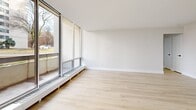 Located at 377 Ridelle Ave in Toronto's Glencairn neighbourhood, this thoughtfully renovated 2-bedroom, 1-bathroom unit offers a clean, modern aesthetic throughout its well-proportioned single-floor layout. Light hardwood flooring flows continuously through every room, lending a bright and cohesive feel to the space.

The kitchen has been fully updated with white cabinetry, quartz countertops, stainless steel appliances including a refrigerator, electric range, over-the-range microwave, and dishwasher, all accented by sleek matte black hardware. A peninsula provides additional counter space and connects the kitchen to the open living area. Floor-to-ceiling windows in the living room flood the space with natural light and open onto a private balcony with views of surrounding greenery and the neighbourhood streetscape.

Both bedrooms are well-sized, featuring light neutral walls, hardwood floors, double-door closets, and baseboard heating. The primary bedroom offers a comfortable footprint, while the second bedroom is equally functional. The bathroom is finished in a crisp white palette with tile flooring, a full soaker tub, and matte black fixtures that complement the unit's consistent design language. A hallway connects all rooms efficiently, completing this clean and functional layout.