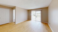 Located at 2501 Erin Way in Paragould, Arkansas, this 2-bedroom, 1-bathroom single-floor unit offers a practical and comfortable layout across a well-proportioned floor plan. The living room is bright and open, featuring light wood-tone flooring, warm neutral walls with textured ceilings, and a sliding glass door fitted with vertical blinds that allows natural light to fill the space and provides access to the outdoors. A pass-through window connects the living area to the kitchen, adding a convenient and functional design touch. The kitchen is equipped with white cabinetry and standard appliances. Both bedrooms are carpeted in a warm beige tone and feature windows with horizontal blinds that invite natural light. The spacious primary bedroom includes two closets — one of which is a walk-in — offering ample storage. The second bedroom is generously sized with a large window overlooking the exterior. The full bathroom is clean and straightforward, featuring a tub-shower combination, toilet, and wood-tone flooring. A hallway and closet round out the layout, contributing to efficient use of space throughout. The unit's cohesive neutral palette and functional design create a comfortable, move-in-ready living environment.