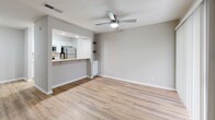 Located at 8601 Roberts Dr in Sandy Springs, GA, this one-bedroom, one-bathroom residence offers a thoughtfully designed single-floor layout. Light wood-look flooring runs throughout, complementing the neutral gray walls and white trim to create a clean, cohesive aesthetic.

The combined dining and living area is open and airy, anchored by a ceiling fan and connected to the kitchen via a pass-through breakfast bar — ideal for both everyday living and entertaining. The kitchen is well-appointed with white shaker-style cabinetry, granite-look countertops, stainless steel appliances including a refrigerator, electric range, microwave, and dishwasher, and a pantry for additional storage.

The bedroom is a comfortable, well-proportioned retreat featuring a ceiling fan, a window with natural light, and access to two closets, including built-in shelving. A dedicated laundry area adds everyday convenience.

The bathroom is finished with a white vanity, granite-look countertop, a tub/shower combination with tile surround, and matching wood-look flooring. A utility room and hallway complete the functional layout. The overall design is modern and move-in ready, with consistent finishes throughout.