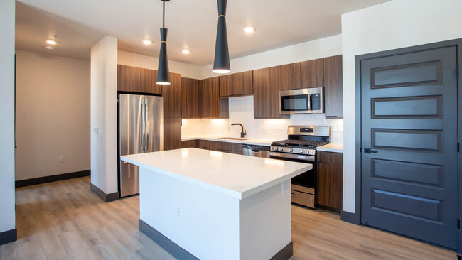 Kitchen with Breakfast Bar and Stainless Steel Appliances - Circa Fitzsimons