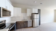 Located on Applerock Drive in O'Fallon, Missouri, this well-designed 2-bedroom, 1-bathroom home offers a thoughtfully laid-out single-floor plan with a clean, contemporary aesthetic. Light hardwood-style flooring flows throughout the entire space, creating a cohesive and modern feel.

The kitchen is a standout feature, showcasing a two-tone cabinet design with rich dark lower cabinets contrasting crisp white upper cabinetry. A classic subway tile backsplash adds texture, while light countertops and a stainless steel appliance suite — including a refrigerator, range, microwave, and dishwasher — complete the functional and stylish space. A tall dark pantry cabinet provides additional storage.

The full bathroom is neatly appointed with dark wood vanity cabinetry, light countertops, and a full tub-shower combination, all set against clean white walls and warm hardwood-style flooring.

Both bedrooms are bright and airy, with neutral wall tones and windows that allow natural light to filter in. The generously sized primary bedroom includes a ceiling fan, while both rooms offer a calm, versatile backdrop suitable for a variety of furnishing styles. A dedicated closet provides convenient storage. The overall ambiance of the home is fresh, modern, and move-in ready.