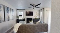 Located at 711 Brentford Pl in Arlington, TX, this well-appointed one-bedroom, one-bathroom residence offers a thoughtfully designed single-floor layout that maximizes every square foot. The living room is a standout space, anchored by a fireplace and complemented by multiple windows dressed in white curtains that invite abundant natural light. A ceiling fan with a sleek brushed-nickel finish adds both style and function overhead, while wood-look flooring runs throughout, tying the space together cohesively. The dining area features a sliding glass door that opens to a private outdoor area, enhancing the sense of openness and airflow. The kitchen is outfitted with stainless steel appliances, including a range with overhead microwave, white cabinetry, and a classic subway tile backsplash. The bedroom is a comfortable retreat with its own ceiling fan, warm neutral tones, a dedicated closet, and room for a full furniture arrangement. The bathroom includes a full tub-shower combination with clean white tile surround. Throughout the home, a neutral color palette, modern fixtures, and consistent wood-look flooring create a cohesive and contemporary ambiance suited for everyday living.
