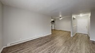 Located at 3563 E Manhattan Blvd in Toledo, Ohio, this single-floor, two-bedroom, one-bathroom home offers a practical and well-maintained layout. Throughout the space, durable wood-look laminate flooring and neutral gray walls create a clean, consistent aesthetic complemented by textured ceilings and white trim.

The open living area is generously proportioned, featuring baseboard heating and a seamless flow into the dining and kitchen area. The kitchen is equipped with dark cabinetry, a white range, and a ceiling fan overhead. Natural light enters through multiple windows dressed with blinds, brightening each room.

Both bedrooms are comfortably sized, with the primary bedroom offering ample floor space and a large window that allows natural light to filter in. The second bedroom includes a wall-mounted air conditioning unit, baseboard heating, and its own window. One bedroom features a built-in double-door closet, providing convenient storage. A dedicated closet space is also accessible from the common area.

The bathroom is straightforward and functional, featuring a full tub and shower combination, a toilet, and wood-look flooring. The home's simple, updated finishes and efficient single-floor design make it a practical and move-in-ready option in the Toledo area.