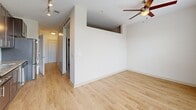 Located at 101 Reedy View Dr in downtown Greenville, SC, this one-bedroom, one-bathroom unit offers a well-designed single-floor layout that makes efficient use of its intimate footprint. The main living area features light wood-style flooring and crisp white walls, creating a clean, bright atmosphere. A ceiling fan overhead adds both function and style, while a hallway leads to the remaining rooms, providing a logical and practical flow throughout the space.

The bedroom is a cozy, carpeted retreat finished with the same neutral white walls and fitted with its own ceiling fan. Elevated architectural detailing near the upper wall adds a subtle design element that enhances the room's character.

The bathroom is thoughtfully appointed, showcasing a dark-toned vanity with granite countertops, an undermount sink, and brushed nickel hardware. Light wood-look tile flooring ties the space together, offering a warm contrast to the cabinetry. The layout is functional and clean, with ample storage below the vanity.

A sliding-door closet in the bedroom area provides organized storage, while track lighting in the hallway ensures the space remains well-lit throughout. The overall design is modern and cohesive, with neutral tones and quality finishes that lend the unit a polished, move-in-ready appeal.
