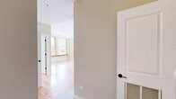 Located at 350 Robert St N in downtown Saint Paul, this two-bedroom, two-bathroom residence offers a thoughtfully designed single-floor layout with generous living space. Warm, natural hardwood floors run throughout, tying each room together with a consistent, classic character. The open kitchen and living area forms the heart of the home, featuring rich cherry wood cabinetry, dark granite countertops, stainless steel appliances, and a peninsula with an undermount sink — ideal for both cooking and entertaining. Large windows fitted with blinds flood the space with natural light and provide views of the surrounding cityscape. The primary bedroom is a comfortable retreat, highlighted by multiple windows, a sliding barn door, and access to a spacious walk-in closet outfitted with extensive built-in shelving. The second bedroom is well-proportioned with its own window and hardwood flooring. Both bathrooms continue the refined aesthetic with cherry wood vanities and granite countertops; the primary bath features a dual-sink vanity and a glass-enclosed shower, while the second bath includes its own shower and single vanity. A dedicated hallway and closet provide additional storage and organization throughout this well-appointed urban residence.