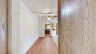Located at 154 Juliann Dr in Wood Dale, IL, this well-proportioned 2-bedroom, 2-bathroom residence offers comfortable single-floor living with a thoughtful layout. The spacious living area features neutral-toned carpeting and a ceiling fan, creating an open, airy atmosphere that flows seamlessly toward the kitchen. The kitchen is equipped with warm wood cabinetry, dark granite-style countertops, a double stainless steel sink, and a full suite of stainless steel appliances including a gas range, microwave, and dishwasher, all set above easy-care hardwood-style flooring. Both bedrooms are generously sized with plush carpeting, warm wood trim, and natural light from windows with views of the surrounding greenery. The primary bedroom is notably spacious and includes ample room for furnishings. Each bathroom features rich wood-toned cabinetry with white countertops and hardwood-style flooring; one includes a tub-shower combination with white tile surround, while the other offers a clean, functional layout with brushed nickel fixtures. A private balcony provides pleasant outdoor views of the landscaped grounds and mature trees. The entrance and dedicated closet space add to the practical functionality of this well-maintained residence.