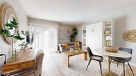 Located at 2886 S Circle Dr in Colorado Springs, CO, this efficiently designed single-floor unit makes excellent use of its compact footprint. The open living area is bathed in natural light streaming through large sliding glass doors fitted with vertical blinds, leading out to a private patio. Light wood-tone flooring, neutral warm-gray walls, and a textured ceiling create an inviting, cohesive atmosphere throughout.

The living space is thoughtfully arranged to maximize functionality, featuring a built-in Murphy bed unit with integrated open shelving — an ideal space-saving solution. The kitchen is a standout, showcasing white shaker cabinetry, granite countertops, a sleek gray subway tile backsplash, stainless steel appliances, and wood-toned flooring that ties seamlessly into the main living area.

The hallway connects the living space to the two bathrooms, which feature large-format tile flooring and distinctive decorative details, including a striking cluster of gold-framed circular mirrors. A glass-enclosed shower area adds a modern touch. A dedicated closet provides practical storage.

The unit's layout is completed by an outdoor patio, offering a private outdoor retreat. Overall, the space strikes a balance between compact efficiency and stylish, modern living.