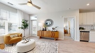 Located at 2020 W Morehead St in Charlotte, NC, this single-floor residence offers a thoughtfully designed open-concept layout with modern finishes throughout. The living area features light wood-style flooring, a ceiling fan, and a glass door that invites natural light while providing access to the outdoors. A seamless flow connects the living space to the kitchen, which is outfitted with crisp white cabinetry, subway tile backsplash, stainless steel appliances including a full-size refrigerator and range, and a peninsula with bar seating — ideal for casual dining or entertaining. The bedrooms are carpeted for comfort, each benefiting from large windows with exterior views that fill the rooms with natural light. The primary suite includes a walk-in closet and an en-suite bathroom with a glass-enclosed shower, wood-look flooring, and a vanity with ample storage. A second full bathroom features a soaking tub with subway tile surround and matching light wood-look floors. Neutral tones and clean architectural lines create a bright, cohesive ambiance throughout the residence, making it a polished and functional living space in the heart of Charlotte.