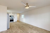 Located at 3115 Glenarm Rd in Colorado Springs, Colorado, this single-floor, 2-bedroom, 2-bathroom home offers a clean, modern aesthetic throughout. The open-concept kitchen and living area serves as the heart of the home, featuring light wood-style flooring, crisp white walls, and a stylish ceiling fan with a brushed brass finish. The kitchen is well-appointed with white shaker cabinetry, a tile backsplash, granite-style countertops, and a full suite of stainless steel appliances including a refrigerator with ice maker, range, built-in microwave, and dishwasher. Natural light filters in through multiple windows fitted with horizontal blinds. Both bedrooms offer a calm, neutral palette with the same wood-style flooring and ample natural light. The primary bedroom includes a walk-in closet with built-in shelving, while the second bedroom features a double closet. Each bathroom is finished with white tile surround tub/shower combinations, white vanity cabinetry, and granite-style countertops. Additional highlights include a dedicated utility room, extra closet storage, and an outdoor balcony. The layout flows efficiently from front entry through the living and kitchen space to the private bedrooms and baths at the rear.