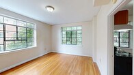 Located at 804 W Morgan St in Raleigh, NC, this one-bedroom, one-bathroom unit offers a well-organized single-floor layout designed to maximize its compact footprint. Warm hardwood floors run throughout the living areas and bedroom, providing a cohesive and inviting atmosphere. Multi-pane windows with black frames are a defining architectural feature, appearing in nearly every room to fill the space with abundant natural light and frame views of surrounding greenery and neighboring brick buildings.

The living room offers a comfortable, open feel, while the bedroom provides a private retreat complete with a dedicated closet and large windows overlooking the tree-lined surroundings. Three closets throughout the unit offer generous storage for a space of this size.

The kitchen is efficiently designed with warm wood cabinetry, granite countertops with rich veining, a stainless steel range, and tile flooring. A window above the counter brings in natural light, making the kitchen feel bright and functional.

The bathroom features classic white tile on both the floors and walls, a full soaking tub with shower, and a wood-toned vanity, creating a clean and timeless aesthetic. A hallway connects the rooms, completing this thoughtfully laid-out Raleigh residence.