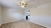 Located at 5100 Highpoint Rd in Union City, GA, this one-bedroom, one-bathroom unit offers a well-organized, single-floor layout designed to maximize every inch of available space. Throughout the unit, wood-look plank flooring provides a clean, cohesive look, while neutral gray-toned walls create a bright and airy atmosphere.

The combined living and dining area serves as the heart of the home, featuring a ceiling fan with integrated lighting and a textured ceiling. A window allows natural light to filter in, and an open pass-through connects directly to the kitchen, enhancing the sense of openness.

The galley-style kitchen is efficiently designed with white cabinetry, light countertops, a single-basin sink, and a full suite of black appliances including an electric range, dishwasher, and refrigerator. An under-cabinet range hood and ample upper and lower cabinet storage round out the functional space.

The bedroom is a comfortable, well-proportioned retreat featuring a ceiling fan, a window with blinds offering natural light and outdoor views, and two closets providing generous storage. The full bathroom includes a tiled shower-tub combination with chrome fixtures and a clean white vanity.