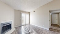 Located at 2810 Woodland Hills Dr in Colorado Springs, CO, this one-bedroom, one-bathroom unit offers a well-organized single-floor layout designed for comfortable, efficient living. The living room is bright and welcoming, featuring wood-style plank flooring, neutral warm-toned walls, a textured ceiling, and a tiled fireplace that serves as a natural focal point. A sliding glass door with vertical blinds opens to a private balcony, where sweeping views of the Rocky Mountains and the surrounding Colorado Springs landscape create a striking backdrop. The kitchen is positioned adjacent to the living area and features dark cabinetry, light granite-style countertops, a double stainless steel sink, and stainless steel appliances. The bedroom offers carpeted flooring for comfort, a built-in closet with shelving, and access through a hallway connecting to the rest of the unit. The bathroom includes wood-style plank flooring, a granite-topped vanity with dark cabinetry, and a full tub-shower combination with clean white tile surround. A dedicated closet provides additional storage. Throughout the unit, natural light filters in generously, enhancing the airy, neutral palette and creating a bright, inviting atmosphere year-round.