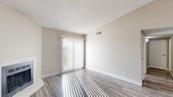Located at 2810 Woodland Hills Dr in Colorado Springs, CO, this one-bedroom, one-bathroom unit offers a well-organized single-floor layout designed for comfortable, efficient living. The living room is bright and welcoming, featuring wood-style plank flooring, neutral warm-toned walls, a textured ceiling, and a tiled fireplace that serves as a natural focal point. A sliding glass door with vertical blinds opens to a private balcony, where sweeping views of the Rocky Mountains and the surrounding Colorado Springs landscape create a striking backdrop. The kitchen is positioned adjacent to the living area and features dark cabinetry, light granite-style countertops, a double stainless steel sink, and stainless steel appliances. The bedroom offers carpeted flooring for comfort, a built-in closet with shelving, and access through a hallway connecting to the rest of the unit. The bathroom includes wood-style plank flooring, a granite-topped vanity with dark cabinetry, and a full tub-shower combination with clean white tile surround. A dedicated closet provides additional storage. Throughout the unit, natural light filters in generously, enhancing the airy, neutral palette and creating a bright, inviting atmosphere year-round.