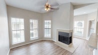 Located at 17717 Vail St in Dallas, Texas, this single-story home offers a well-organized layout with thoughtfully designed living spaces. The living room serves as the heart of the home, showcasing a tiled fireplace as a focal point, vaulted ceilings, a stylish ceiling fan, and light wood-look flooring. Multiple windows with blinds allow generous natural light to fill the space, creating a bright and welcoming atmosphere. An adjacent room, also featuring vaulted ceilings and a ceiling fan, offers flexibility as a dining area or secondary living space, with windows providing additional natural light and outdoor views. The galley-style kitchen is efficiently laid out with white cabinetry, granite-style countertops, a stainless steel sink, and black appliances, including a range and over-the-range microwave. The bedroom features plush carpeting, a ceiling fan, a window for natural light, and access to a dedicated walk-in closet with built-in shelving. The bathroom is clean and functional, outfitted with wood-look flooring, a granite-topped vanity, and a full tub-shower combination. Neutral wall tones and consistent finishes throughout the home create a cohesive and move-in-ready aesthetic.