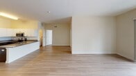 Located at 222 Norristown Rd in Warminster, PA, this single-floor unit offers a clean, contemporary layout with a neutral color palette and light hardwood flooring throughout the main living areas. The open kitchen is equipped with stainless steel appliances, including a refrigerator, range, and microwave, complemented by dark lower cabinetry, white upper cabinets, and granite countertops — a functional and stylish space for cooking and entertaining. The living area is bathed in natural light and features sliding glass doors that open onto a private balcony, offering pleasant outdoor views of surrounding trees. Multiple rooms throughout the unit are generously sized, each benefiting from large windows fitted with blinds that allow for flexible light control. The bedroom is particularly well-lit, with three windows providing multi-directional natural light and treetop views. A hallway connects the living spaces to the bathroom, which includes large-format tile flooring, a tiled shower enclosure with sliding glass doors, and a vanity with granite countertops. The overall design is modern and move-in ready, with a bright, airy ambiance that emphasizes clean lines and practical functionality throughout.