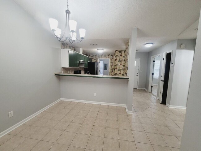 Building Photo - LOVELY 3/2 w/ Screened Porch, New Carpet in Bedrooms, Washer/Dryer, & Privacy Fenced Yard! Includ...