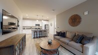 Located at 3930 S Lake Dr in St. Francis, Wisconsin, this single-floor unit offers a thoughtfully designed open-concept layout that seamlessly connects the living and kitchen areas. The living room features warm neutral tones, light wood-style flooring, and large windows with roller shades that invite natural light into the space. The kitchen is a standout, showcasing crisp white shaker cabinetry, granite countertops, stainless steel appliances, and a central island with bar seating illuminated by pendant lighting — ideal for both cooking and casual dining. Recessed lighting throughout ensures a bright, welcoming atmosphere. The bedroom is a comfortable retreat, carpeted for warmth and equipped with a ceiling fan, dual windows providing outdoor views, and ample space for furnishings. The bathroom continues the home's clean aesthetic with granite countertops, white cabinetry, and neutral tile flooring. Consistent use of neutral gray and warm beige tones, modern hardware, and quality finishes give the entire unit a cohesive, contemporary feel. The efficient single-level floor plan makes for easy navigation and everyday living, making this St. Francis residence a well-rounded and modern living space.