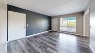 Located on Avocado Street in Costa Mesa, California, this single-floor, three-bedroom, one-bathroom residence offers a thoughtfully designed layout with modern finishes throughout. The open living areas feature sleek hardwood-style flooring in a cool gray tone, complemented by neutral wall colors and large windows that invite abundant natural light. A bold accent wall in the living area adds a contemporary touch, while sliding glass doors provide views of the surrounding neighborhood.

The kitchen is well-appointed with crisp white cabinetry, light quartz countertops, a mosaic tile backsplash, and stainless steel appliances including a gas range and refrigerator. A peninsula-style counter adds additional prep and dining space, enhancing both functionality and flow.

The spacious primary bedroom features plush carpeting, mirrored sliding closet doors, and ample natural light. The additional bedrooms are equally comfortable, each carpeted with good-sized windows and generous closet space. A hallway connects the bedroom wing to the main living areas seamlessly.

The bathroom is clean and bright, outfitted with white cabinetry, quartz countertops, a large vanity mirror with warm-toned framing, and a full shower-tub combo with modern fixtures. The wood-look tile flooring ties the space together with a cohesive, updated aesthetic throughout the home.