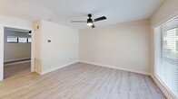 Located at 501 Branard St in Houston's vibrant Montrose neighborhood, this thoughtfully updated one-bedroom, one-bathroom unit offers a well-designed single-floor layout. Light wood laminate flooring flows consistently throughout the space, creating a cohesive and contemporary feel.

The open kitchen/living area serves as the heart of the unit. The kitchen stands out with crisp white shaker cabinets, dark granite countertops, a light blue subway tile backsplash, stainless steel appliances including a refrigerator, range, microwave, and dishwasher, and a matte black faucet. An overhead sputnik-style chandelier adds a modern touch. The adjacent living area benefits from a large sliding glass door that invites natural light and provides outdoor views.

The generously sized bedroom features neutral walls, a ceiling fan with built-in lighting, a closet, and a horizontal window that brings in additional natural light. In-unit stacked laundry is conveniently accessible from the bedroom area.

The bathroom is clean and modern, featuring a white vanity with a dark countertop, a glass-enclosed walk-in shower, and a stylish wall-mounted light fixture. White trim and neutral tones throughout the unit contribute to a bright, fresh ambiance.