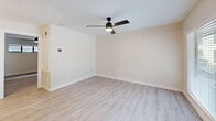 Located at 501 Branard St in Houston's vibrant Montrose neighborhood, this thoughtfully updated one-bedroom, one-bathroom unit offers a well-designed single-floor layout. Light wood laminate flooring flows consistently throughout the space, creating a cohesive and contemporary feel.

The open kitchen/living area serves as the heart of the unit. The kitchen stands out with crisp white shaker cabinets, dark granite countertops, a light blue subway tile backsplash, stainless steel appliances including a refrigerator, range, microwave, and dishwasher, and a matte black faucet. An overhead sputnik-style chandelier adds a modern touch. The adjacent living area benefits from a large sliding glass door that invites natural light and provides outdoor views.

The generously sized bedroom features neutral walls, a ceiling fan with built-in lighting, a closet, and a horizontal window that brings in additional natural light. In-unit stacked laundry is conveniently accessible from the bedroom area.

The bathroom is clean and modern, featuring a white vanity with a dark countertop, a glass-enclosed walk-in shower, and a stylish wall-mounted light fixture. White trim and neutral tones throughout the unit contribute to a bright, fresh ambiance.