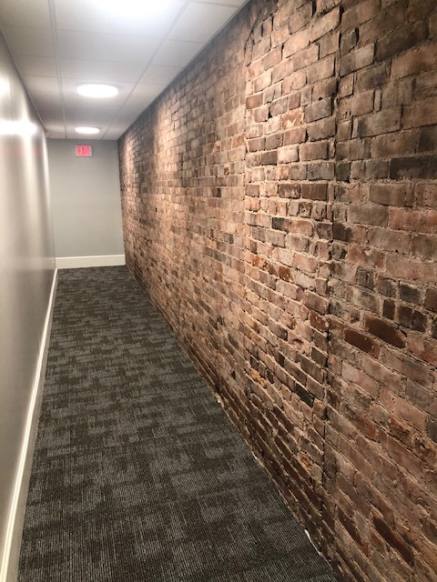 Brick accented hallway - Fitch Block Apartments