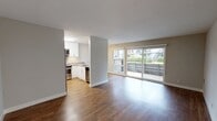 Located at 609 Catamaran St in Foster City, California, this single-floor residence offers a clean, modern aesthetic throughout. The open-concept living and dining area is anchored by warm hardwood flooring that extends seamlessly through the main living spaces, creating a cohesive and inviting atmosphere. Large sliding glass doors flood the living room with natural light and provide direct access to a private balcony overlooking lush greenery, offering a pleasant outdoor retreat.

The kitchen is efficiently designed with white cabinetry, stainless steel appliances including a range, microwave, and refrigerator, complemented by a tile backsplash and a breakfast bar counter. A ceiling fan overhead adds comfort to the adjacent dining nook. The kitchen's semi-open layout connects it naturally to the living area while maintaining a defined sense of separation.

The bedrooms feature the same rich hardwood flooring, neutral-toned walls, and windows that bring in natural light and views of the surrounding landscape. One bedroom includes a mirrored closet, enhancing the sense of space. The bathroom is equipped with a full soaking tub and shower combination with clean white surround walls. Throughout the residence, a neutral color palette and well-maintained finishes contribute to a bright, move-in ready environment.