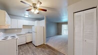 Located at 2625 Verde Dr in Colorado Springs, CO, this one-bedroom, one-bathroom unit offers a practical and comfortable single-floor layout. The kitchen is efficiently designed in a U-shaped configuration, featuring white cabinetry, a coil-burner electric range, dishwasher, refrigerator, and a sink — all set atop wood-look vinyl flooring that adds warmth and durability. A ceiling fan with a light kit is centrally positioned, serving both the kitchen and adjacent areas. The open transition between the kitchen and living room creates a connected feel, with the living room featuring plush carpet flooring, a baseboard heating system, and a sliding glass door fitted with vertical blinds that opens to a balcony overlooking a tree-lined outdoor area, allowing natural light to fill the space. The bedroom is generously proportioned, offering soft carpet flooring, a large window with vertical blinds providing natural light, a baseboard heater, and a double-door louvered closet. The bathroom includes a full-size soaking tub with a tiled surround and a combined shower, complemented by a textured wall finish. Three closets throughout the unit provide ample storage. The overall aesthetic is clean and neutral, offering a move-in-ready foundation.
