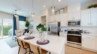 Located at 22025 Avalon Landing Ln in Cypress, TX, this single-story home offers a thoughtfully designed open-concept layout across a comfortable footprint. Light wood flooring flows seamlessly throughout, creating a cohesive and airy feel from room to room.

The kitchen is a standout feature, outfitted with white shaker cabinetry extending to the ceiling, a white quartz waterfall island with bar seating, subway tile backsplash, and a full suite of stainless steel appliances including a French door refrigerator, range, over-the-range microwave, and dishwasher. Pendant lighting above the island adds a polished touch. The kitchen opens directly to the entrance and living areas, promoting easy flow throughout the home.

The living room is bright and welcoming, featuring a large window with natural light, a sliding glass door that opens to the outdoors, and ample wall space for art display. The bedroom is a serene retreat with a generously sized window, warm neutral tones, and access to natural light. The bathroom includes a white vanity with quartz countertop, a tiled walk-in shower, and a walk-in closet. Recessed lighting throughout and a clean, neutral palette complete this well-finished home.