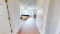 This single-floor studio in Birmingham's Southside neighborhood offers a well-designed, open layout that maximizes functionality throughout. The main living area features wood-style flooring and crisp white walls, creating a clean, modern aesthetic. Large windows flood the space with natural light and frame views of the surrounding Birmingham cityscape, adding an airy, expansive feel to the room. A ceiling fan provides additional comfort overhead.

The kitchen is fully equipped with stainless steel appliances, including a refrigerator, range, microwave, and dishwasher. Light wood cabinetry pairs with granite-style countertops to provide ample storage and prep space. A dedicated in-unit laundry area with a stacked washer and dryer is conveniently tucked adjacent to the kitchen.

The bathroom features the same wood-style flooring found throughout the unit, complemented by a granite-topped vanity with light wood cabinetry, a combination tub and shower with grab bars, and a window for natural ventilation. The overall design of the studio prioritizes clean lines and practicality, making it a functional and well-lit urban living space in the heart of Birmingham.