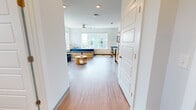This single-floor studio in Birmingham's Southside neighborhood offers a well-designed, open layout that maximizes functionality throughout. The main living area features wood-style flooring and crisp white walls, creating a clean, modern aesthetic. Large windows flood the space with natural light and frame views of the surrounding Birmingham cityscape, adding an airy, expansive feel to the room. A ceiling fan provides additional comfort overhead.

The kitchen is fully equipped with stainless steel appliances, including a refrigerator, range, microwave, and dishwasher. Light wood cabinetry pairs with granite-style countertops to provide ample storage and prep space. A dedicated in-unit laundry area with a stacked washer and dryer is conveniently tucked adjacent to the kitchen.

The bathroom features the same wood-style flooring found throughout the unit, complemented by a granite-topped vanity with light wood cabinetry, a combination tub and shower with grab bars, and a window for natural ventilation. The overall design of the studio prioritizes clean lines and practicality, making it a functional and well-lit urban living space in the heart of Birmingham.