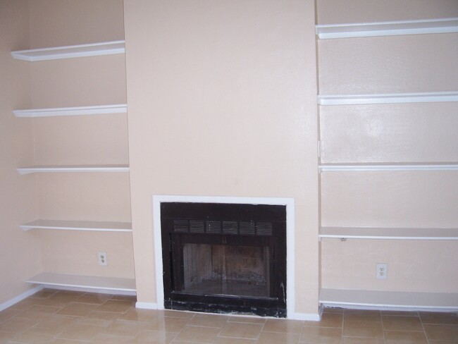 Fireplace surrounded by shelves - 14521 Clovelly Wood