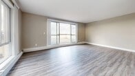 Located at 190 Cherryhill Cir in London, Ontario, this well-appointed two-bedroom, two-bathroom unit offers a thoughtfully designed single-floor layout with a clean, modern aesthetic throughout. Light-toned laminate flooring runs continuously through the space, lending a cohesive and contemporary feel to every room.

The living area is a standout feature, bathed in natural light from large sliding glass doors that open directly onto a balcony, offering open outdoor views. The kitchen is efficiently laid out with light grey cabinetry, a top-freezer refrigerator, under-cabinet lighting, and a neutral tile backsplash, providing practical function with a fresh, modern look.

The primary bedroom is generously sized, featuring a sliding glass door with balcony access and abundant natural light. Both bedrooms are equipped with built-in closets, including double-door and bi-fold configurations that maximize storage. A second bedroom also includes a dedicated closet with shelving and hanging space.

The two bathrooms are finished in a clean, contemporary style. One features a wide vanity with white countertop, modern cabinetry, and a large mirror, while the other includes both a soaking tub and a glass-enclosed shower. The hallway entry features a staircase with white railings and a built-in closet, completing this practical and well-designed home.