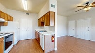 Located at 1600 Mustang Dr in Marble Falls, TX, this well-designed 2-bedroom, 3-bathroom unit offers a comfortable and functional single-floor layout. Wood-look flooring flows consistently throughout the entire space, giving it a cohesive and clean appearance.

The open living room is bright and airy, featuring vaulted ceilings, a ceiling fan, and multiple windows with horizontal blinds that invite generous natural light and outdoor views of surrounding greenery. A pendant light fixture highlights the dining area, which connects seamlessly to the galley-style kitchen. The kitchen is equipped with warm oak cabinetry, white countertops, a double sink, a range, and a dishwasher, along with a pantry closet for additional storage.

Both bedrooms are well-proportioned, each featuring a ceiling fan, a window overlooking the outdoors, and a double-door closet for ample storage. The primary bedroom offers a notably spacious footprint. The three bathrooms are consistent in finish, each featuring warm oak vanity cabinetry, white countertops, a large mirror, and overhead lighting. One bathroom includes a full soaking tub, while others include accessibility features such as grab bars. A central hallway connects the bedrooms and bathrooms, providing a practical and easy-to-navigate flow throughout the home.