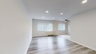 Located at 6451–6461 Oxford Avenue in Philadelphia's Fox Chase neighborhood, this single-floor unit combines clean, contemporary design with practical functionality. The open-concept layout connects the living and dining areas seamlessly, creating a generous, airy feel. Recessed lighting throughout the main living spaces provides consistent illumination, while a ceiling fan adds both comfort and visual interest. Large windows fitted with vertical blinds invite natural light and offer views of the surrounding greenery.

The living areas feature light-toned wood-style flooring that extends through much of the unit, contributing to a cohesive and modern aesthetic. Crisp white walls and clean baseboard trim reinforce the bright, neutral palette throughout.

The kitchen is well-appointed with rich dark espresso cabinetry, marble-style countertops, a tiled backsplash in soft gray tones, and stainless steel fixtures, offering a notable contrast to the lighter finishes found elsewhere in the unit. A black refrigerator anchors the space.

The bedrooms are carpeted for comfort and include closet space. The bathroom features a clean white vanity, light tile flooring, and a tub-shower combination with a subtle tile accent border, maintaining the unit's consistent, refreshed aesthetic.