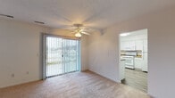Located at 3109 Remington Court North Dr in Mishawaka, Indiana, this single-floor 2-bedroom, 2-bathroom residence offers a clean, functional layout designed for comfortable everyday living. The living room serves as the heart of the home, featuring plush carpeting, a ceiling fan with light fixture, and a large sliding glass door framed by vertical blinds that fills the space with natural light and provides access to an outdoor area with pleasant views. An additional window further brightens the room. The kitchen is well-equipped with crisp white cabinetry, rich stone-look countertops, wood-look vinyl flooring, a double-basin sink, a dishwasher, and a range — offering ample storage and prep space in a practical U-shaped layout. Both bedrooms are carpeted and generously sized, each featuring windows with blinds that allow for natural light and privacy. Closet space is included in the bedrooms for convenient storage. The bathrooms are finished with white cabinetry, stone-look countertops, and large vanity mirrors. One bathroom includes a full tub-shower combination with wood-look flooring, providing a clean and functional space. Overall, the unit presents a neutral, move-in-ready aesthetic throughout.