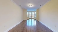 Located at 9-11 Vose Ave in South Orange, NJ, this well-appointed 2-bedroom, 2-bathroom residence offers a thoughtfully designed single-floor layout with generous living space. Rich hardwood floors flow throughout the main living areas, complemented by warm neutral wall tones and crisp white crown molding that lend the home a polished, classic feel. The open living and dining area is bright and airy, anchored by French doors that invite natural light and provide access to an outdoor space. The dining area features elegant hardwood floors and a stylish chandelier, making it ideal for entertaining. The kitchen is equipped with dark espresso cabinetry, stainless steel appliances including a gas range, microwave, and French door refrigerator, as well as light tile flooring and a pendant light fixture. Both bedrooms are carpeted and well-sized, with the primary bedroom offering generous proportions and ample closet space. The bathrooms are finished with tile flooring, dark vanities topped with marble-style counters, and classic subway tile surrounds in the tub and shower. A dedicated in-unit laundry room houses full-size front-loading washer and dryer units. Multiple closets throughout provide excellent storage, rounding out this comfortable and complete residence.
