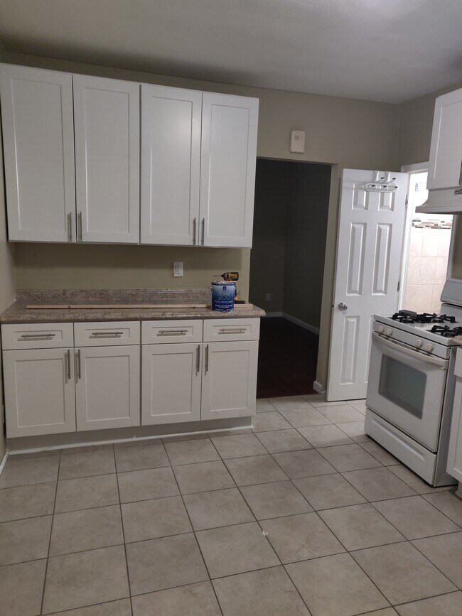 kitchen with bathroom next to the stove - 910 Wilson Ave