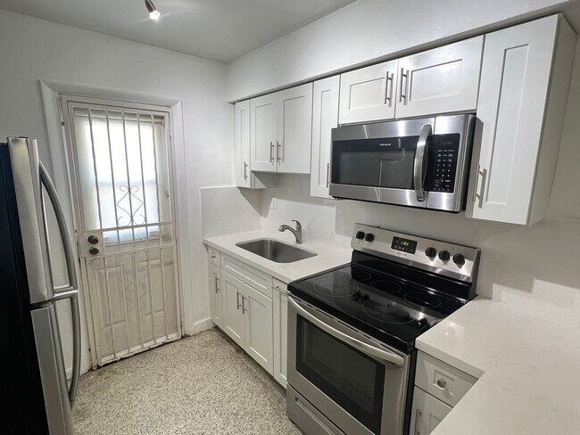 Building Photo - SPACIOUS UPGRADED TWO-BED ONE-BATH UNIT LOCATED IN THE HEART OF LITTLE HAVANA. THE BUILDING HAS A...