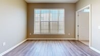 Located in Clinton, Mississippi, this 2-bedroom, 2-bathroom residence offers a thoughtfully designed single-level floor plan that balances comfort and functionality. The open-concept living and kitchen area serves as the heart of the home, featuring durable wood-look plank flooring, recessed lighting, and a seamless flow between spaces. The kitchen is outfitted with crisp white cabinetry, a subway tile backsplash, stainless steel appliances including a refrigerator, range, and microwave, and a peninsula with a light-toned countertop and undermount sink — ideal for both meal prep and casual dining.

The living area is bright and airy, benefiting from a large window that fills the room with natural light. Both bedrooms are carpeted for comfort, with neutral-toned walls and generous proportions. The spacious primary bedroom features its own en-suite bathroom, complete with a wide vanity, white quartz countertop, undermount sink, and framed mirror. The second bathroom mirrors the same clean, modern aesthetic. Additional highlights include a dedicated laundry area with an in-unit washer/dryer and overhead shelving, as well as two closets for ample storage throughout the home.