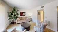 Located at 901 Rob Roy Ct in West Columbia, SC, this two-story, 2-bedroom, 2-bathroom home offers a well-organized layout spread across two floors. The main level hosts the living areas, including a carpeted living room with a textured ceiling, a sliding glass door that fills the space with natural light and provides outdoor views, and room for comfortable seating arrangements. Adjacent to the living room is a dedicated dining area featuring a pendant chandelier, natural light from a window dressed with teal curtains, and neutral carpet flooring. The galley-style kitchen includes warm oak cabinetry, white appliances, light countertops, and tile flooring, with a direct sightline into the living area. A full bathroom on this level features a wood-toned vanity, large mirror, and bright overhead lighting. Upstairs, two bedrooms each feature ceiling fans with lighting, carpeted floors, and closet storage. The primary bedroom is a comfortable size with a window allowing natural light. The second full bathroom is clean and well-appointed with a wood vanity, tile flooring, and a shower-tub combination. Hallways connecting each floor provide easy flow throughout. The textured ceilings are consistent throughout the home, adding a classic residential character.