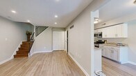 Located at 50 Knollwood Drive in Lancaster, PA, this two-story home offers a thoughtfully designed layout spread evenly across two floors. The main level welcomes you with a bright entry area featuring light wood-style flooring, recessed lighting, and neutral walls that carry throughout the home. The open living room provides a comfortable gathering space anchored by a staircase with a stylish metal railing leading to the upper floor. The kitchen is a standout, equipped with white shaker-style cabinetry, granite countertops, stainless steel appliances including a gas range and built-in microwave, and a deep sink — all complemented by the same light hardwood flooring. A utility room with in-unit laundry is conveniently accessible from the kitchen. Upstairs, two bedrooms offer restful retreats, each with plush carpeting and windows that invite natural light. The primary bedroom features a ceiling fan for added comfort. The full bathroom is elegantly finished with tile flooring, large-format tile surround in the tub/shower combination, dual white vanities with granite countertops, and clean, modern hardware. Hallways on both floors connect the spaces efficiently, completing this move-in-ready home.