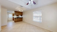 Located at 2124 Kerria Ave in McAllen, Texas, this single-story home offers a practical and comfortable layout across two bedrooms and two bathrooms. Light-toned ceramic tile flooring runs consistently throughout the entire home, creating a clean and cohesive look. The living and entry areas feature tray ceilings accented by ceiling fans, adding architectural interest and promoting airflow. Natural light filters through blinds-covered windows in multiple rooms, enhancing the bright, neutral color palette of cream-toned walls.

The kitchen is a standout feature, showcasing rich wood cabinetry with a custom range hood, dark granite countertops, a built-in breakfast bar, and a white electric range. Adjacent dining space flows seamlessly from the kitchen, making it ideal for everyday use.

The primary bedroom is a comfortable size, also featuring a tray ceiling and a ceiling fan, with a window offering outdoor views. The primary bathroom impresses with a lengthy double-sink vanity, warm wood cabinetry, generous under-counter storage, and a full-width mirror. The second bathroom is clean and functional, equipped with a full tub-shower combo. A dedicated closet provides additional storage within the home.
