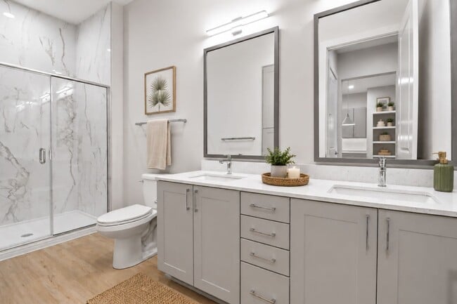 Refined finishes and a modern sensibility transform the bathroom into a space that’s both beautiful and beautifully functional. - Brooking Square Apartments & Townhomes