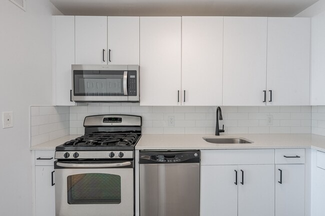 Sleek stainless steel appliances and modern cabinetry - Newport Rentals