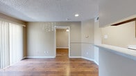 Located at 11800 Pleasant Ridge Rd in Little Rock, AR, this one-bedroom, one-bathroom unit offers a well-organized single-floor layout designed for comfortable everyday living. Rich hardwood flooring flows throughout the entire space, creating a warm and cohesive aesthetic accented by neutral beige walls and white trim.

The open kitchen and living area form the heart of the unit. The kitchen features warm oak cabinetry, light-toned countertops, a stainless steel double sink, and black appliances including a refrigerator, range, dishwasher, and over-range microwave. A peninsula counter with a raised bar separates the kitchen from the living area, which benefits from a sliding glass door that fills the room with natural light and provides outdoor access.

The bedroom is a comfortable, private retreat equipped with a ceiling fan, a window for additional natural light, and direct access to both a dedicated closet and the full bathroom. The bathroom is finished with white tile surrounding a full soaking tub and shower combination. Textured ceilings are present throughout, and the layout makes efficient use of every square foot. This unit offers a practical and functional living environment in a convenient Little Rock location.