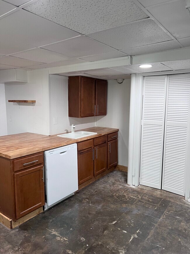 Butcher block countertops, concrete flooring & swinging barn doors leading to the washer/dryer area. - 3367 Lake Valley Rd NW
