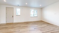 Located at 920 Cedar Pine Dr in Longmont, Colorado, this two-story home offers a bright, modern design spread across two well-proportioned floors. The main level features an open-concept living room with light wood-style flooring, recessed lighting, and a clean, neutral palette that creates an airy, welcoming atmosphere. The kitchen is a standout, boasting white shaker cabinetry, light quartz countertops, a central island with a sink, stainless steel appliances, and large windows that invite natural light. A convenient half bathroom and laundry area round out the main floor. Upstairs, three bedrooms provide comfortable retreats, with the primary bedroom featuring its own closet access and plush carpeting. The upper level also includes additional bathrooms finished with white subway tile surround tub-showers, wood-look flooring, and crisp white vanities with under-cabinet storage. Bedrooms are appointed with ceiling fans, windows with neighborhood views, and generous closet space — five closets in total throughout the home. The consistent use of light tones, recessed lighting, and clean finishes throughout both floors gives the home a cohesive, move-in-ready feel.