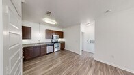 Located in Austin, TX, this one-bedroom, one-bathroom unit offers a well-designed single-floor layout that maximizes functionality. The open-concept kitchen and living area form the heart of the space, where rich dark-wood cabinetry, granite countertops, and a full suite of stainless steel appliances — including a refrigerator, electric range, built-in microwave, and dishwasher — create a well-equipped culinary space. Pendant lighting and crown molding add refined detail throughout. Wood-style plank flooring runs seamlessly across all areas, lending a cohesive, modern feel. The living area is bright and airy, with a ceiling fan and access to natural light through blinds-fitted windows. The bedroom is a comfortable, private retreat complete with its own ceiling fan, a large window for natural light, and direct access to a dedicated closet. The bathroom features a full tub-shower combination with tile surround, granite-topped vanity, dark wood cabinetry for storage, and wood-style flooring consistent with the rest of the unit. Clean white walls and crown molding throughout contribute to a crisp, contemporary aesthetic well-suited for efficient, comfortable living in the Austin area.