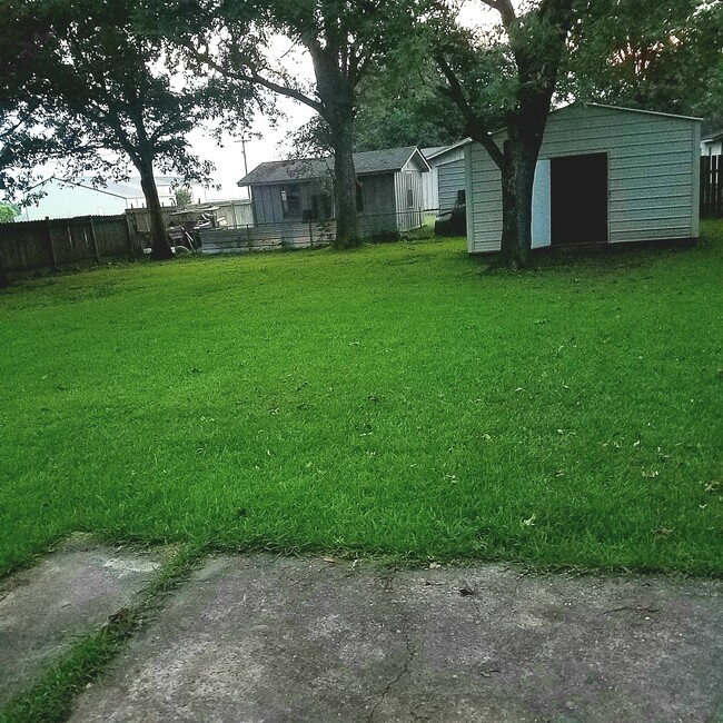 fenced in back yard with private storage - 920 8th Ave
